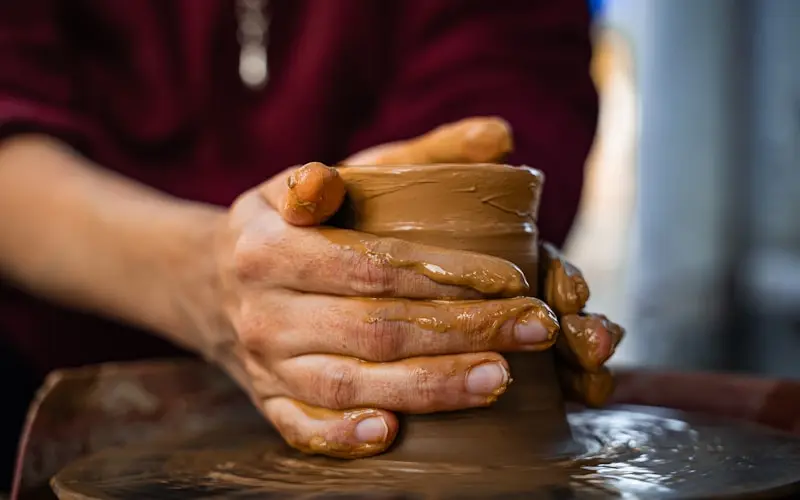 Artisan hands shaping clay